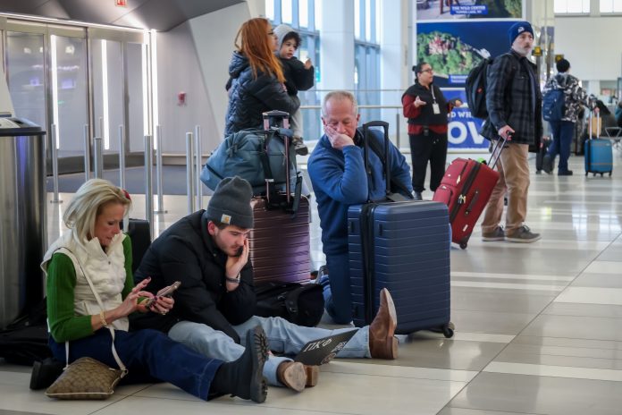 Airlines cancel 1,400 more flights but disruptions from winter storm ease